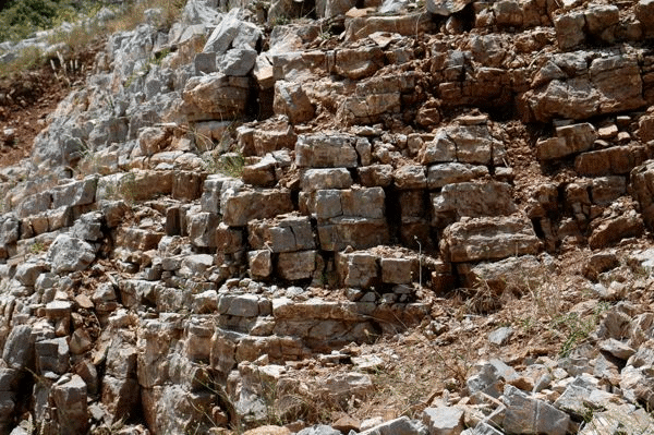 Outcrop expression of weakness of Thin Platy Limestone Beds along fault zones.