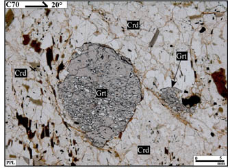 The photomicrographs show garnet porphyroblast within younger mineral phases